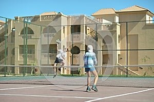 Two boys playing tennis