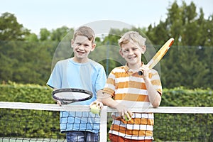 Portrait Of Two Boys Playing Tennis Together