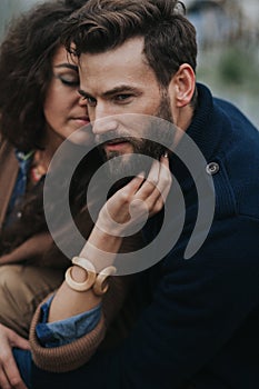 Portrait of two caucasian lovers. Young couple is hugging on autumn day outdoors. A bearded man and curly woman in love. Valentine