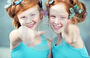 Portrait of two cheerful redhead twins