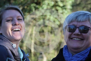 A portrait of two collegue ladies in the nature laughing photo