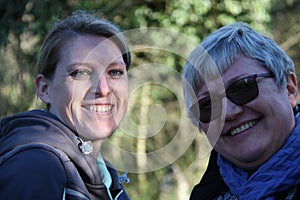 A portrait of two smiling collegue ladies in the nature photo