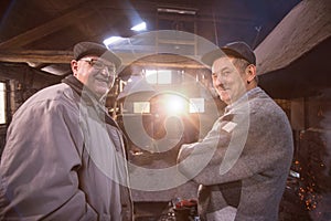 Portrait of two confident senior blacksmith