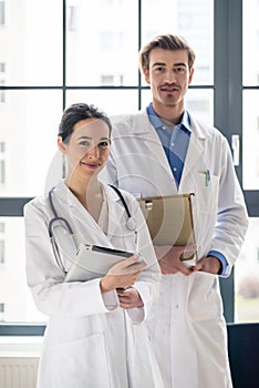 Portrait of two determined physicians looking at camera in a mod