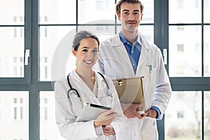 Portrait of two determined physicians looking at camera in a mod