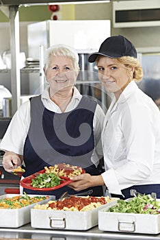 Portrait Of Two Dinner Ladies In School Cafeteria photo