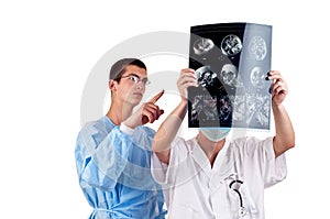 Portrait of two doctors examining a head tomography