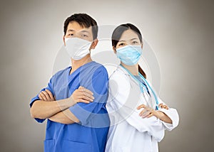 Portrait of two doctors with lab coats, masks and stethoscope working against the coronavirus