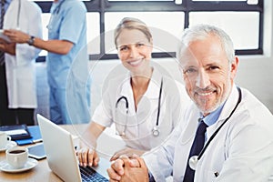 Portrait of two doctors smiling in conference room