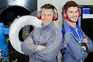 Portrait two engineers wearing earmuffs