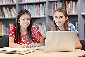 Portrait Of Two Female High School Students Working At Laptop In