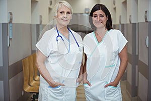 Portrait of two female nurse standing in corridor