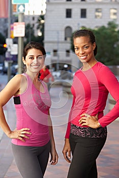 Portrait Of Two Female Runners On Urban Street