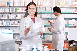 Portrait of two friendly pharmacists working