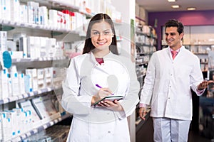 Portrait of two friendly pharmacists working