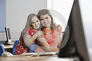Portrait of two girls (10-12) in computer lab