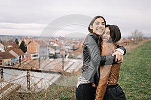 Portrait of two girls hugging themselves tightly