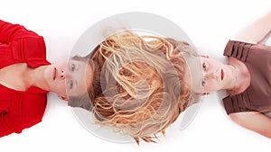 Portrait two girls with intertwined hairs, isolated on white, top view.