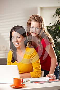 Portrait of two girls with laptop