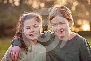 Portrait Of Two Girls Outdoors With Arms Around Each Other