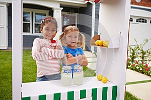 Portrait Of Two Girls Running Homemade Lemonade Stand