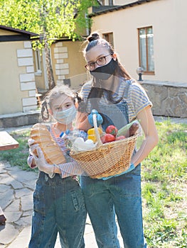 Portrait two girls of the teenager with food packages for the needy during a pandemic coronavirus.