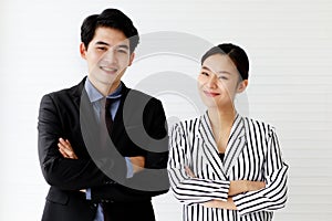 Portrait of two handsome business man and beautiful woman smiling with confidence, crossing their arms and looking to the camera