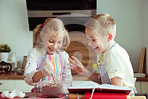 Portrait of two happy children which having fun during cooking c