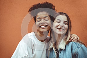 Portrait of two happy joyful teen girls of different races making selfie, enjoying friendship