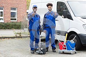 Portrait Of Two Happy Male Janitor