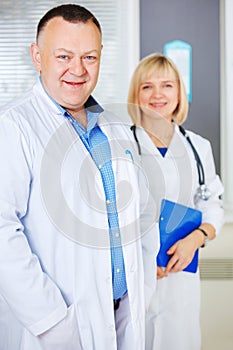 Portrait of two happy mature doctors.