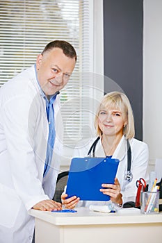 Portrait of two happy mature doctors.