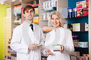 Portrait of two happy pharmacists