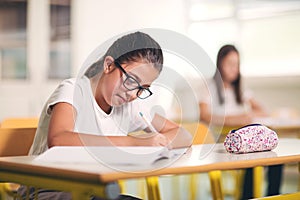 Portrait of two happy schoolgirls in a classroom