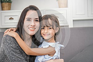 Portrait of two happy sisters in the living room