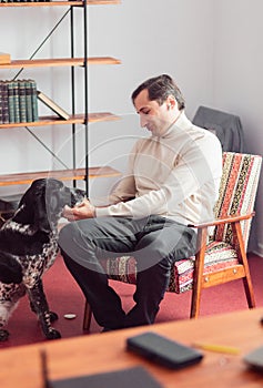 Portrait of two inseparable friends. The black-and-white shorthaired pointer looks attentively at the owner, who