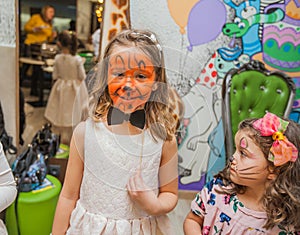 Portrait of two little girls with face painting