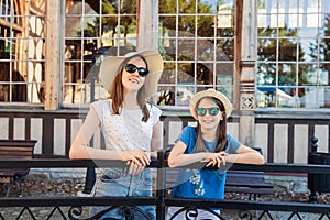 Portrait of two little girls in hats and sunglasses