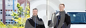 Portrait Of Two Male Electrician Carrying Tool Boxes