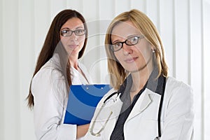 Portrait of Two Medical Colleagues Smiling and Looking at Camera