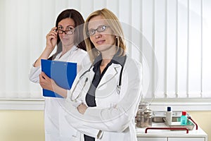 Portrait of Two Medical Colleagues Smiling and Looking at Camera