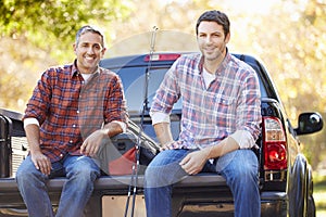 Portrait Of Two Men In Pick Up Truck On Camping Holiday