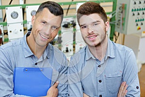 portrait two men working in workshop