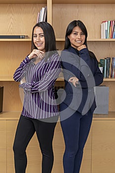 Portrait of two Mexican women in office clothes. Portrait of two female entrepreneurs in formal wear in the lobby