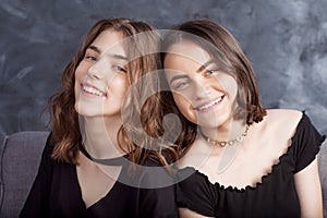 Portrait of two natural  smiling teenage girls. Close up lifestyle portrait of two young girls best friends