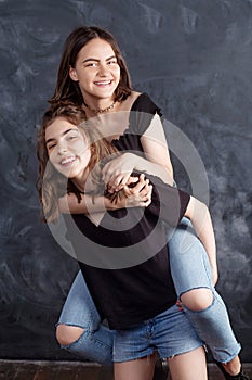 Portrait of two natural  smiling teenage girls. Lifestyle portrait of two young girls best friends.  Beautiful teen girls having