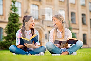 Portrait of two nice attractive cute cheerful cheery glad brainy diligent knowledgeable intelligent pre-teen girls