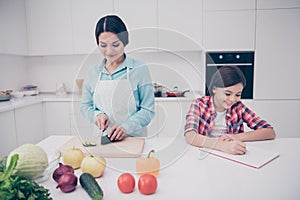 Portrait of two nice cute lovely attractive cheerful cheery dreamy people mom making lunch healthy lifestyle girl doing