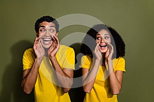 Portrait of two nice people look each other whisper wear t-shirt isolated on khaki color background