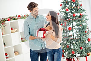 Portrait of two people attractive man give christmas gift package to his woman scream omg enjoy x-mas tradition in house